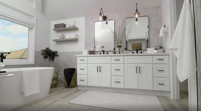 Modern bathroom featuring Bathroom Essentials like towels, toiletries, bath mat, shower curtain, storage organizers, and mirrors.
