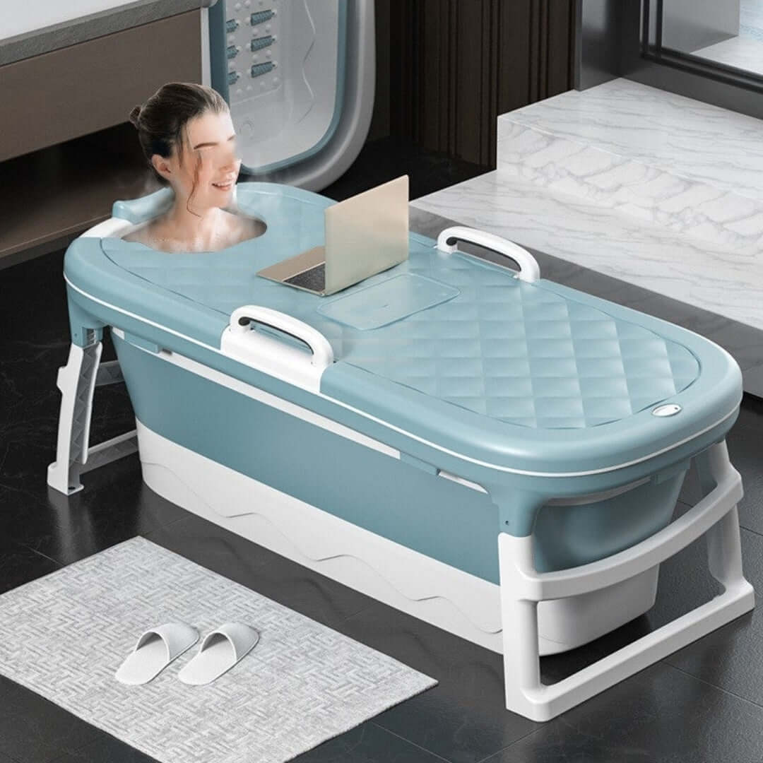Compact indoor bathtub with laptop, part of Home Essentials for a functional home.