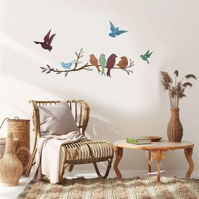 Bird Branch Wall Decoration metal art piece in a cozy living room setting with wicker furniture and earthy decor.