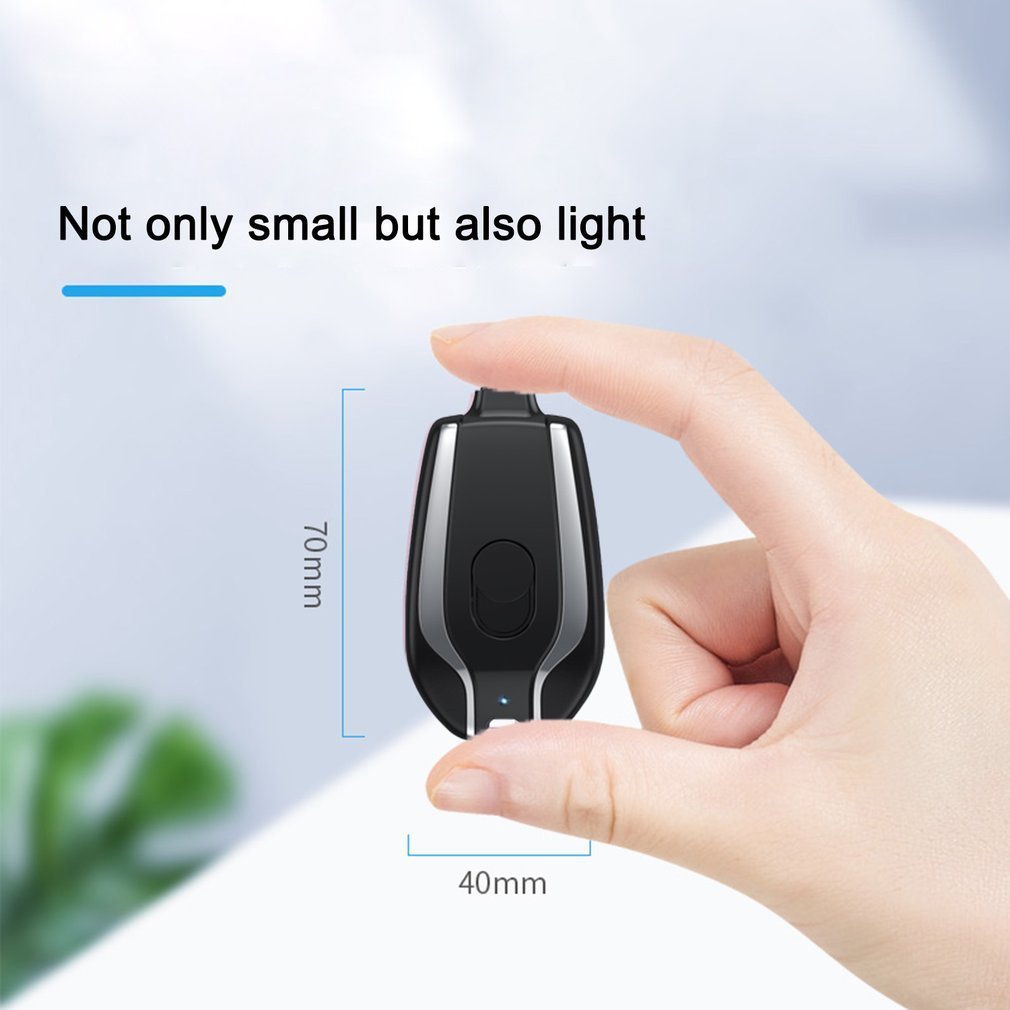 Hand holding 1500mAh Keychain Power Bank, ultra-compact emergency charger with waterproof rubber surface, 70mm x 40mm size.