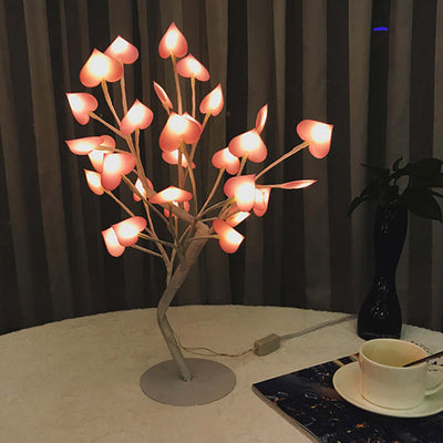 Heart-shaped LED Night Light with fairy wire garland lights on a table, creating a warm ambiance for kid's room and home décor.