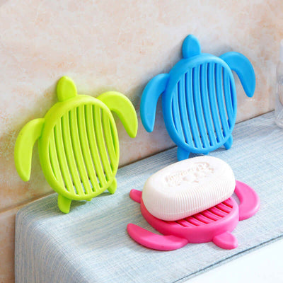 Colorful tortoise-shaped bathroom soap holder with soap on countertop