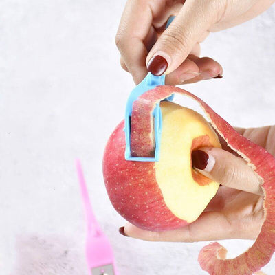 Using Fruit & Vegetable Peeler to peel an apple, showcasing multifunctional finger ring scraper tool for kitchen use.