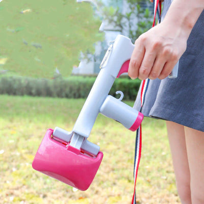 Person holding Portable Pet Waste Picker, a handy pooper scooper for cats and dogs, in a park setting.