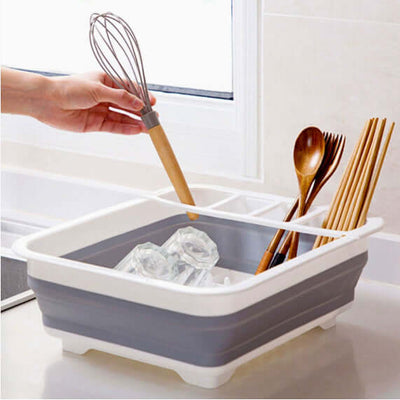 Folding Dish Drying Rack in use, holds kitchen utensils and ice cubes on a countertop
