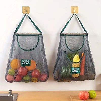 Wall-mounted Kitchen Storage Mesh Bags filled with fruits and vegetables, perfect for organized kitchen storage