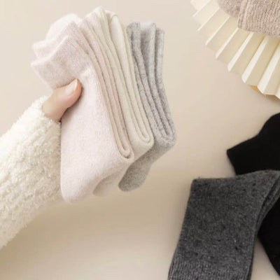 Set of thick cashmere wool socks in pastel shades showcasing premium warmth and comfort for winter.
