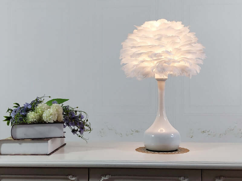 Luxury Feather Table Lamp, touch dimming feature, elegant white goose feather lampshade on a bedside table in home setting.