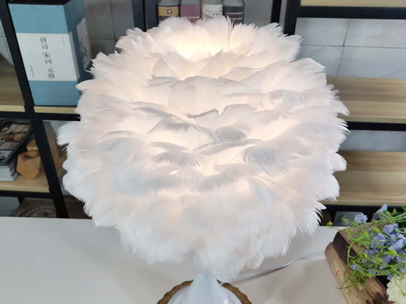Luxury Feather Table Lamp with natural white goose feather lampshade on a bedside table for bedroom and living room.