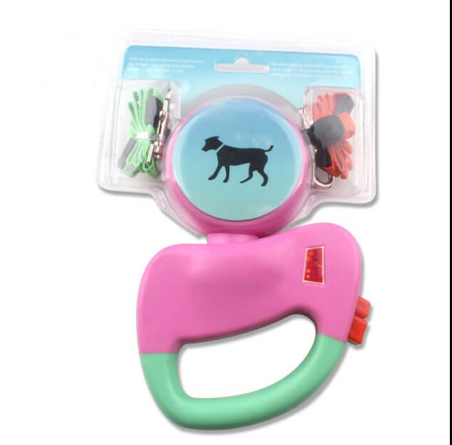 Retractable Dual Dog Leash in pink and green with packaging featuring dog silhouette.
